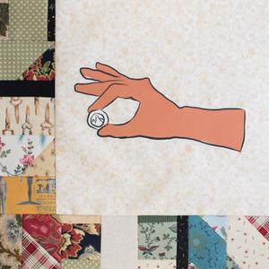 A hand holding a coin.