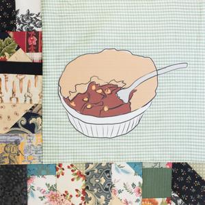 A ramekin of food with a spoon.