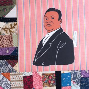 Rufus Estes in a black suit jacket.