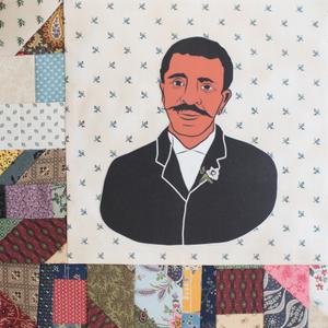 George Washington Carver in a black suit.