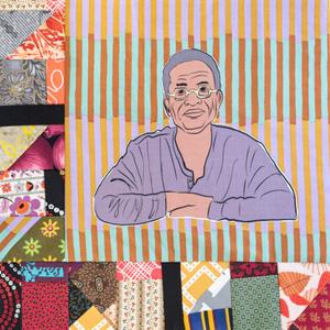 Lolis Elie sitting with his arms crossed.