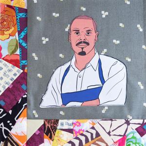 Preston Clark in a blue apron.