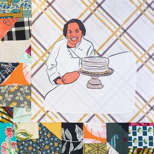 Dolester Miles smiling next to a cake.